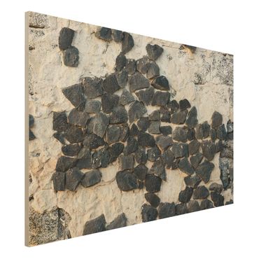 Obraz z drewna - Ściana z czarnymi kamieniami