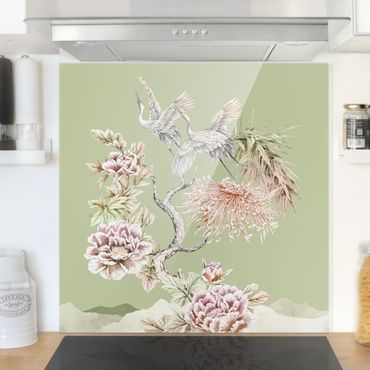 Panel szklany do kuchni - Akwarela Bociany w locie z kwiatami na zielonym tle