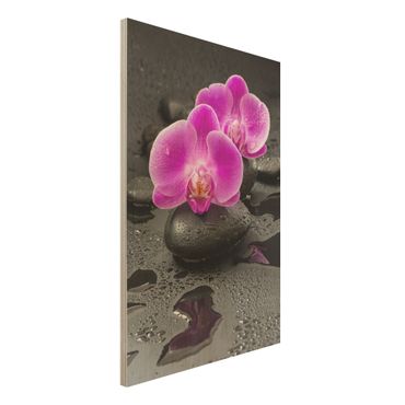 Obraz z drewna - Kwiaty różowej orchidei na kamieniach z kroplami