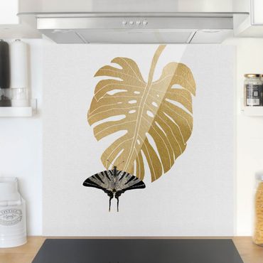 Panel szklany do kuchni - Monstera złocista z motylem