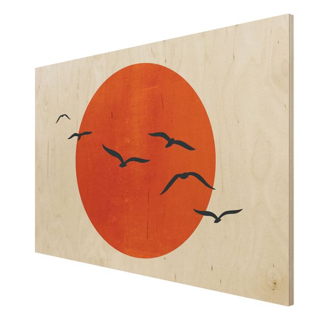 Obrazy na drewnie Stado ptaków na tle czerwonego słońca I