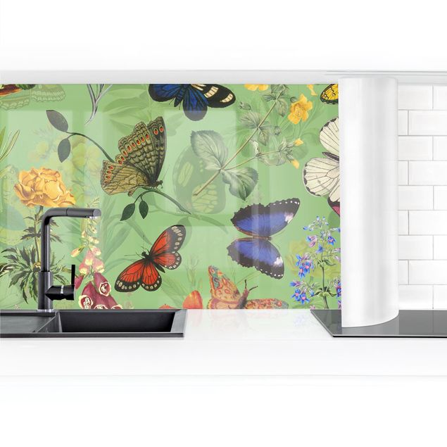 Panele szklane do kuchni Motylki z kwiatami na zielonym tle