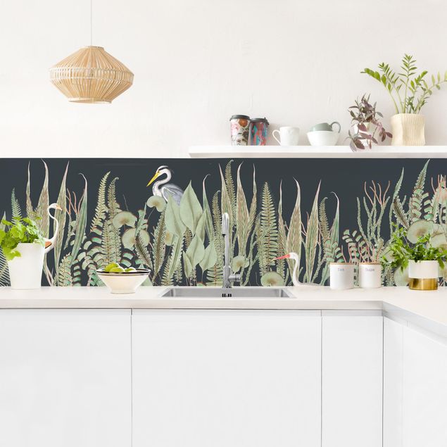 Panele szklane do kuchni Flamingo i bocian z roślinami na zielonym tle