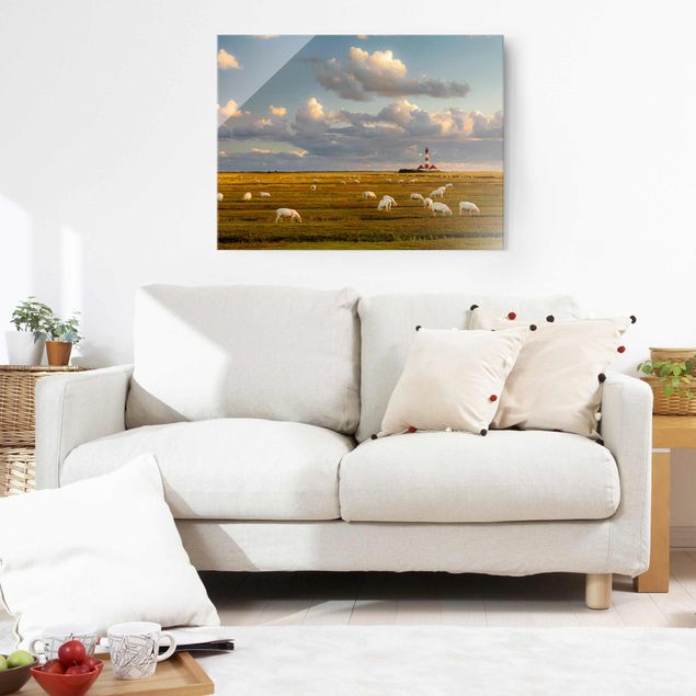 Obrazy na szkle wybrzeże Latarnia morska na Morzu Północnym ze stadem owiec