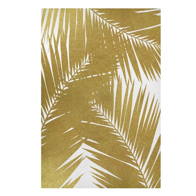 Obrazy kwiatowe Widok przez złote liście palmy