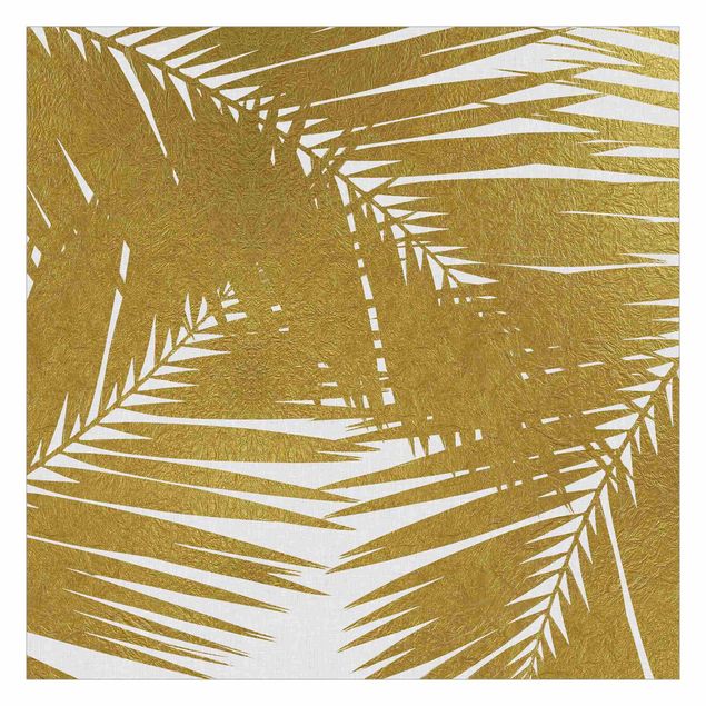 Fototapeta - Widok przez złote liście palmy