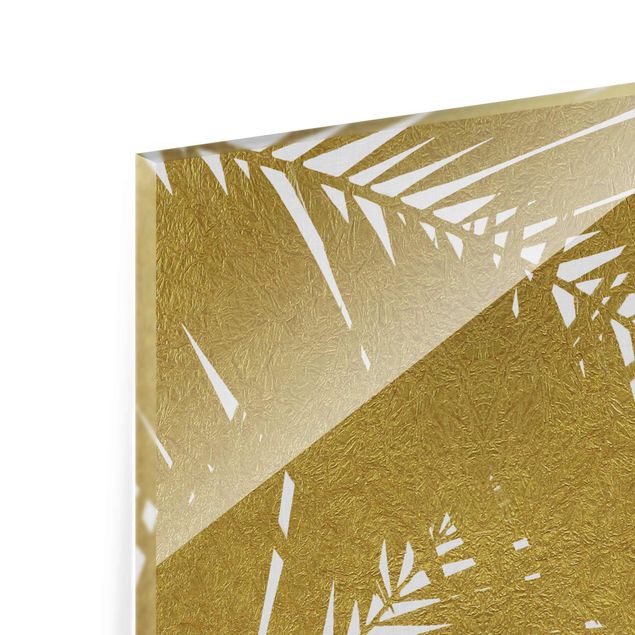 Obrazy z motywem kwiatowym Widok przez złote liście palmy