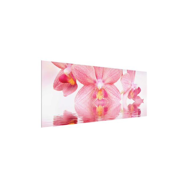 Obrazy na szkle panorama Różowe storczyki na wodzie