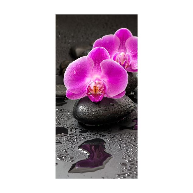 dywany nowoczesne Kwiaty różowej orchidei na kamieniach z kroplami