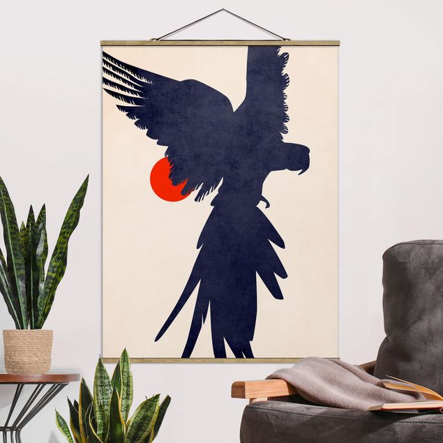 Nowoczesne obrazy do salonu Niebieska papuga na tle czerwonego słońca