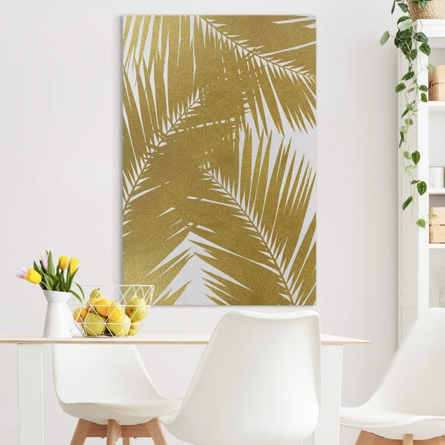 Obraz na płótnie - Widok przez złote liście palmy