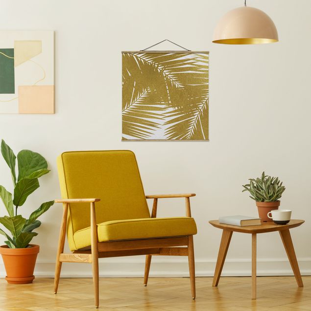 Obrazy do salonu nowoczesne Widok przez złote liście palmy