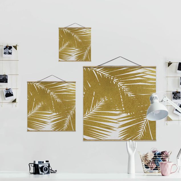 Obrazy na ścianę Widok przez złote liście palmy