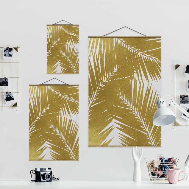 Obrazy na ścianę Widok przez złote liście palmy