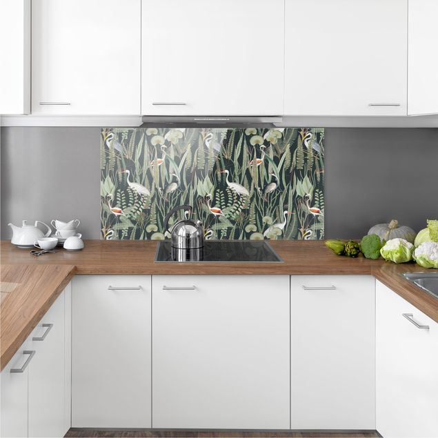 Panel szklany do kuchni Flamingi i bociany z roślinami na zielonym tle