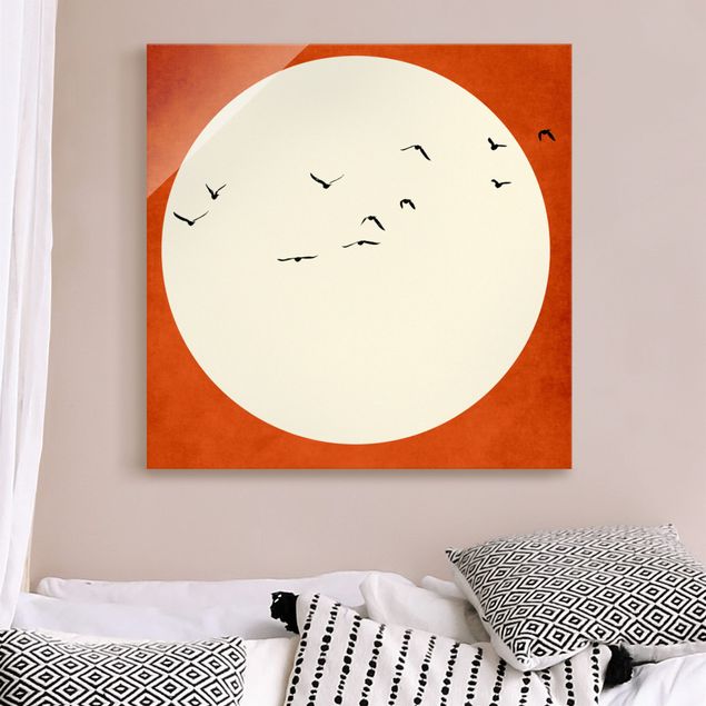 Obrazy na szkle kwadrat Stado ptaków na tle czerwonego zachodu słońca